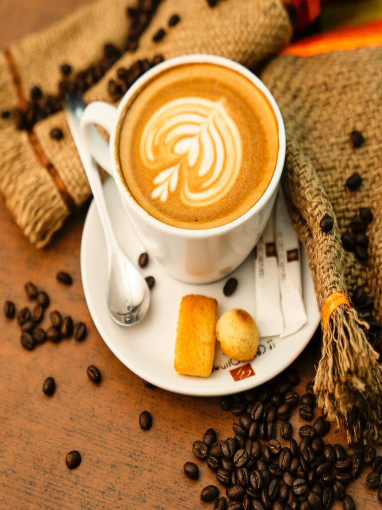 Delicious coffee and snack on a rustic wooden table.