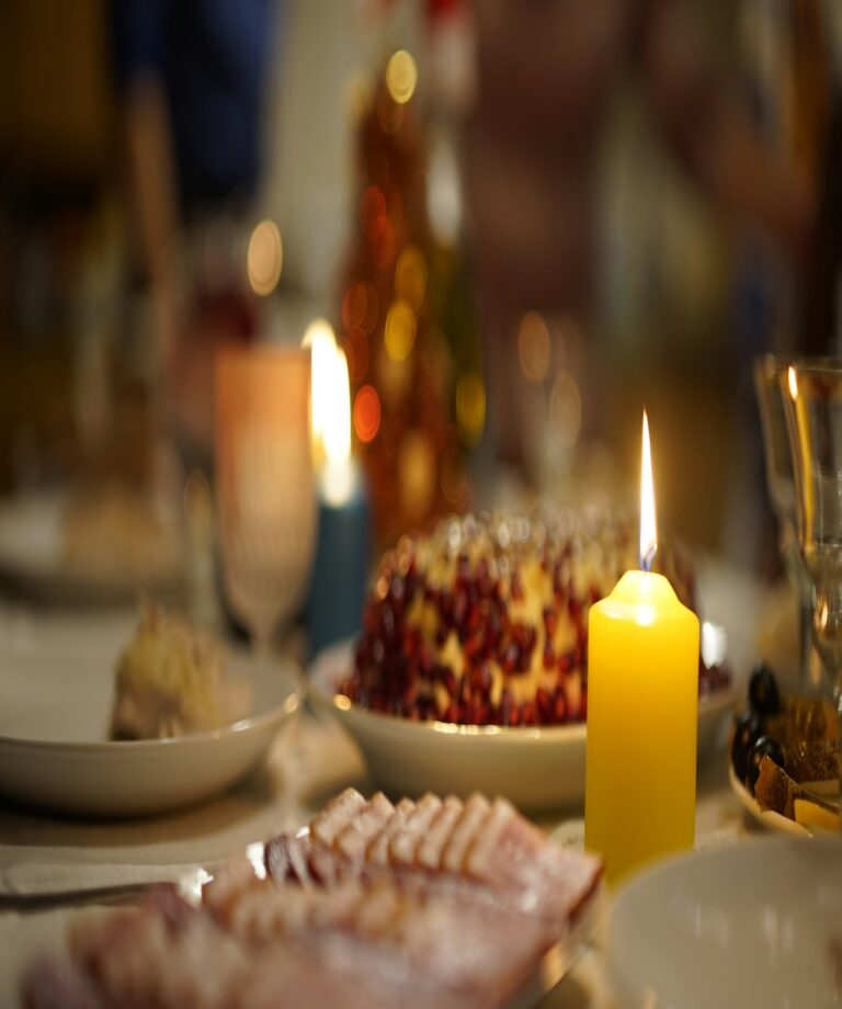 An elegant table display featuring a candle and delicious food.