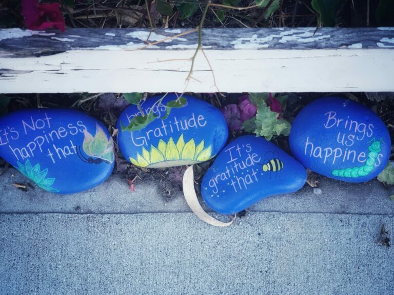 four painted rocks with words written on them