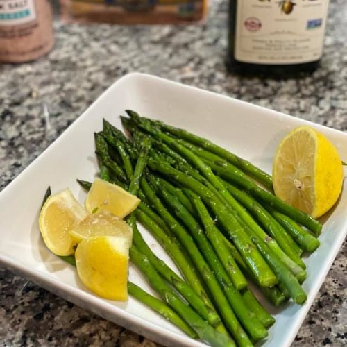 Asparagus with lemon wedges and olive oil.