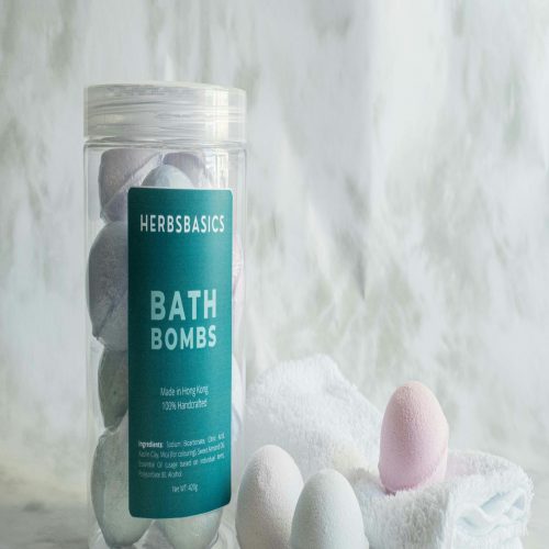 a jar of bath bombs next to a towel