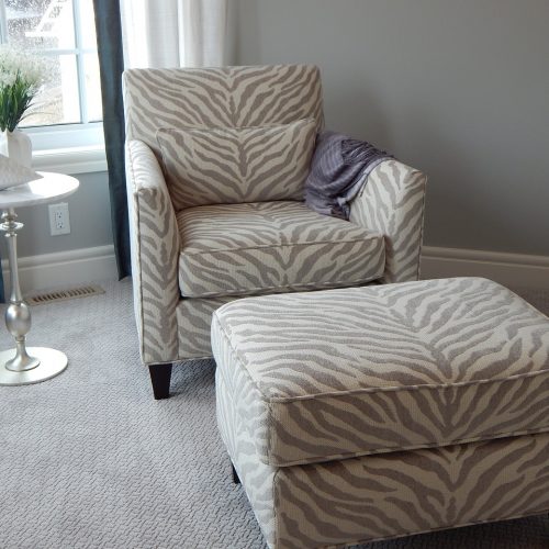 A chair and ottoman placed in a room, creating a cozy and inviting atmosphere.