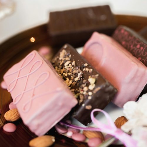 a plate of assorted chocolates and nuts on a table