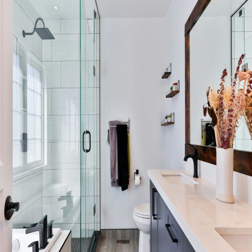 A modern bathroom with a sleek glass shower door and a stylish sink.