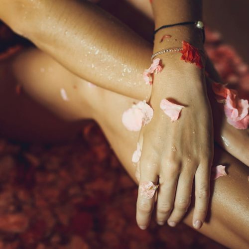 a close up of a person's legs with flowers on them