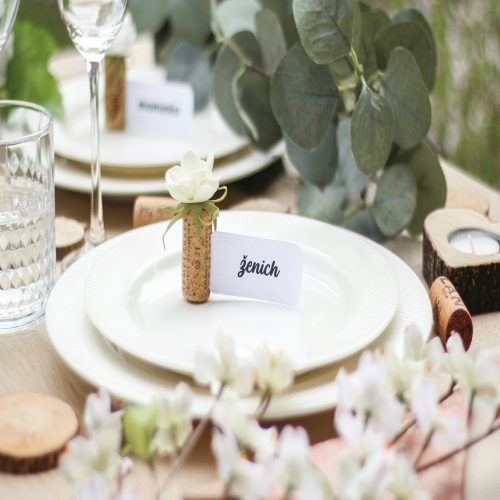 Elegant table setting with white plate, napkin, and place card.