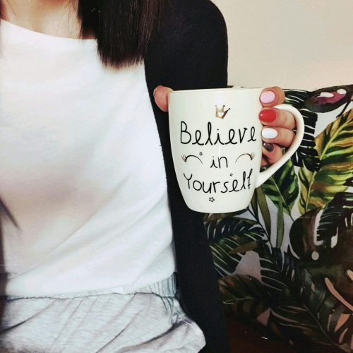 Inspirational coffee cup with words "Believe in Yourself" on it.