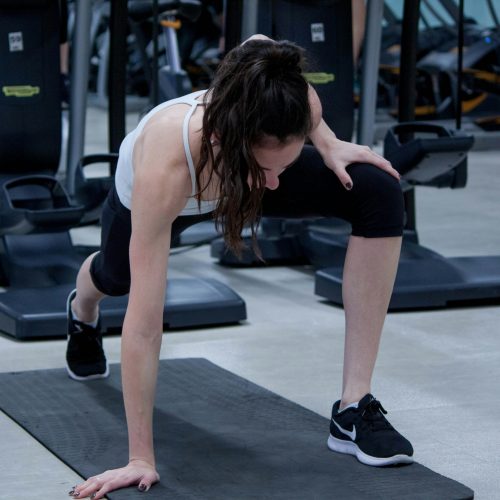 A woman doing a push up on a mat.