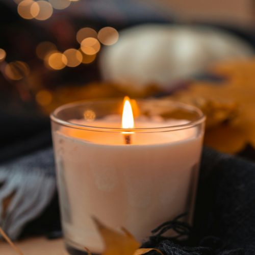 a lit candle sitting on top of a table