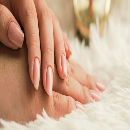 a close up of a person's hands with a manicure