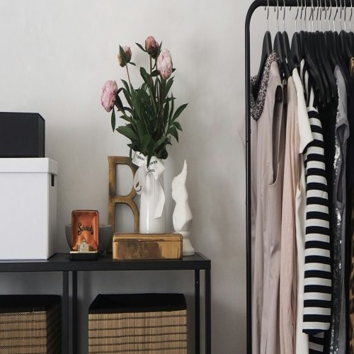 a shelf with a vase of flowers on it