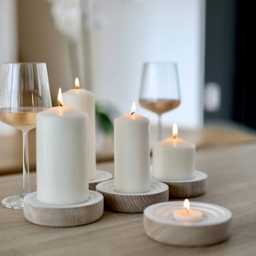 a close up of a table with candles and wine glasses