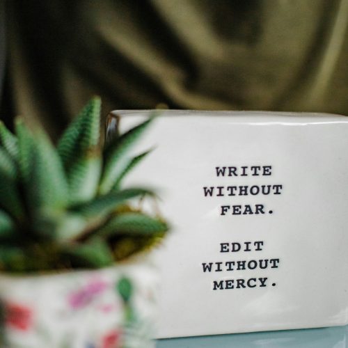 White ceramic mug featuring the empowering phrase "write without fear" in bold black font.