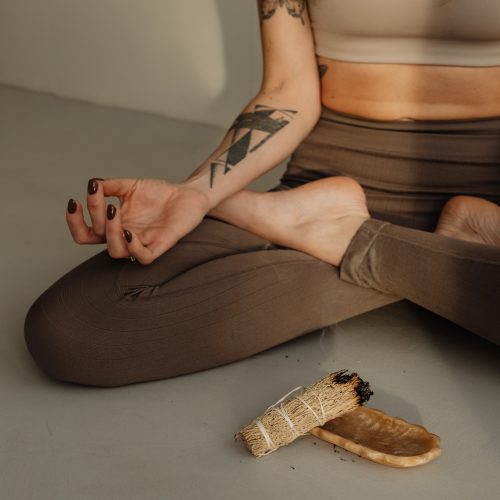 a woman sitting on the floor meditating